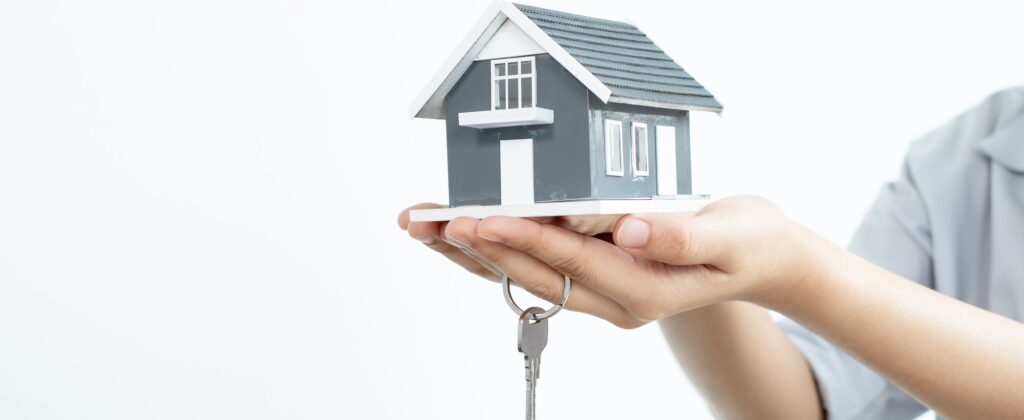Real estate investment agents who hold keys with house designs and lease documents, make home purch